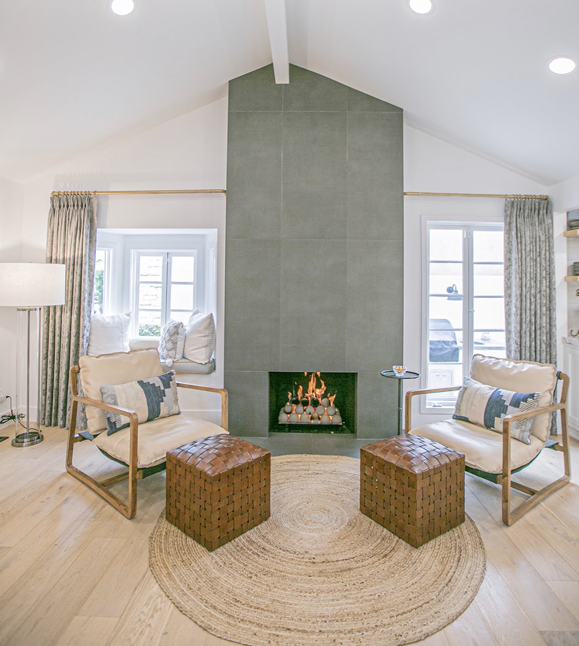 Living room with green tile fireplace