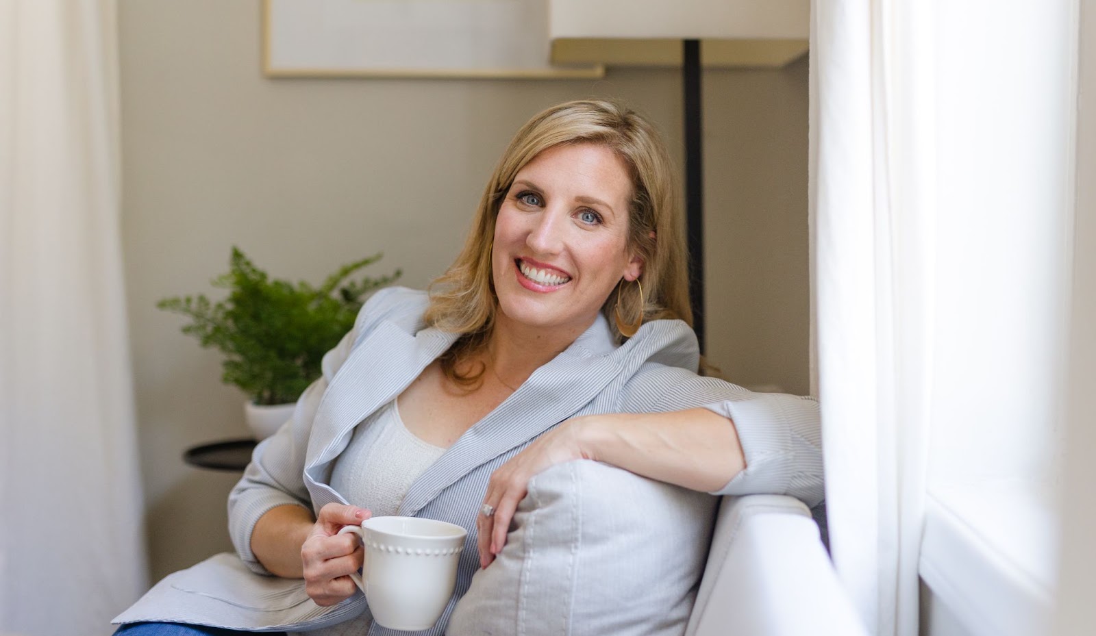 Kelly Elder seated with coffee